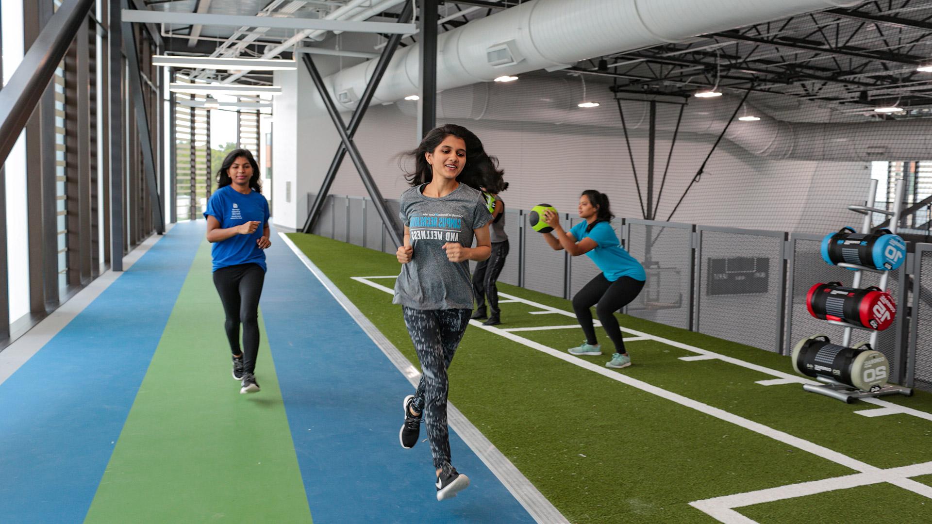 Students running on the Recreation and Wellness Center indoor track.